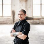 Tenille Evans in chef's suit; pictured in warehouse with floor-to-ceiling windows