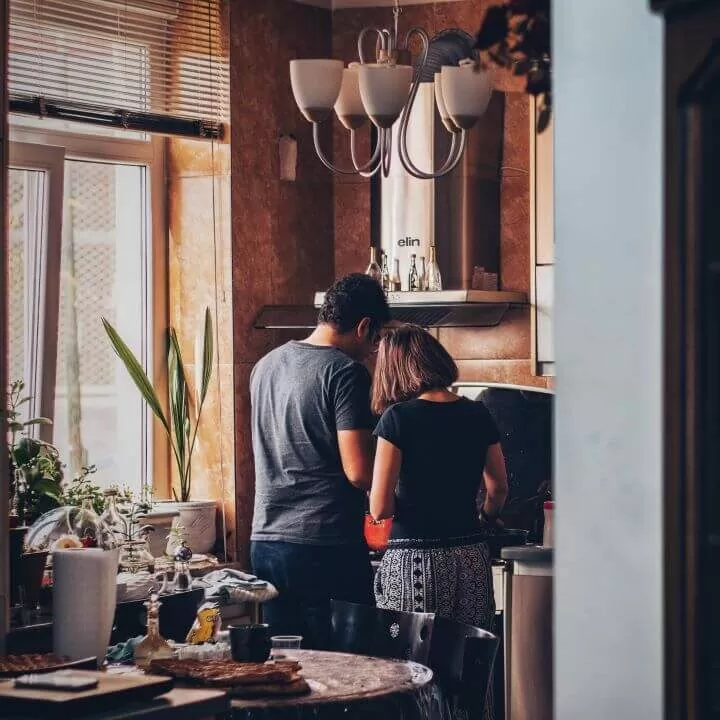 Couple creating delicious vegan dish in sunny kitchen