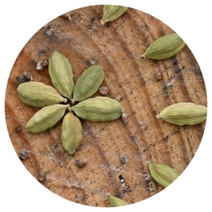 Cardamom pods on wooden surface
