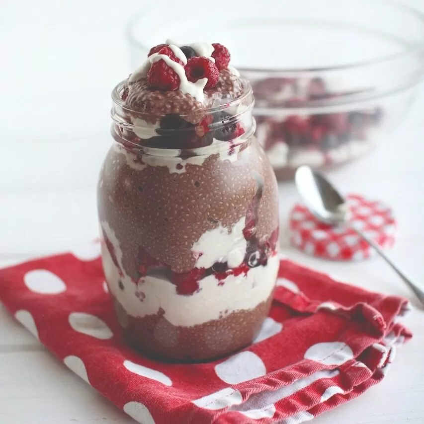 Cacao chia pudding with sweet cashew cream and raspberries