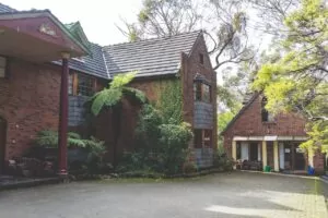 Happy Buddha Retreats main lodge and outbuilding, pictured from outside the main building. Image: Sarah Webb