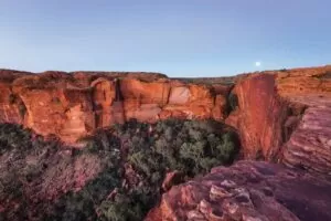 Desert rock formations with vegetation and blue sky overhead