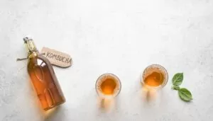Kombucha bottle and two glassfuls