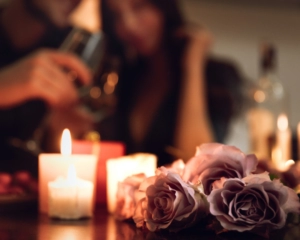 Couple at home enjoying candle-lit vegan dinner